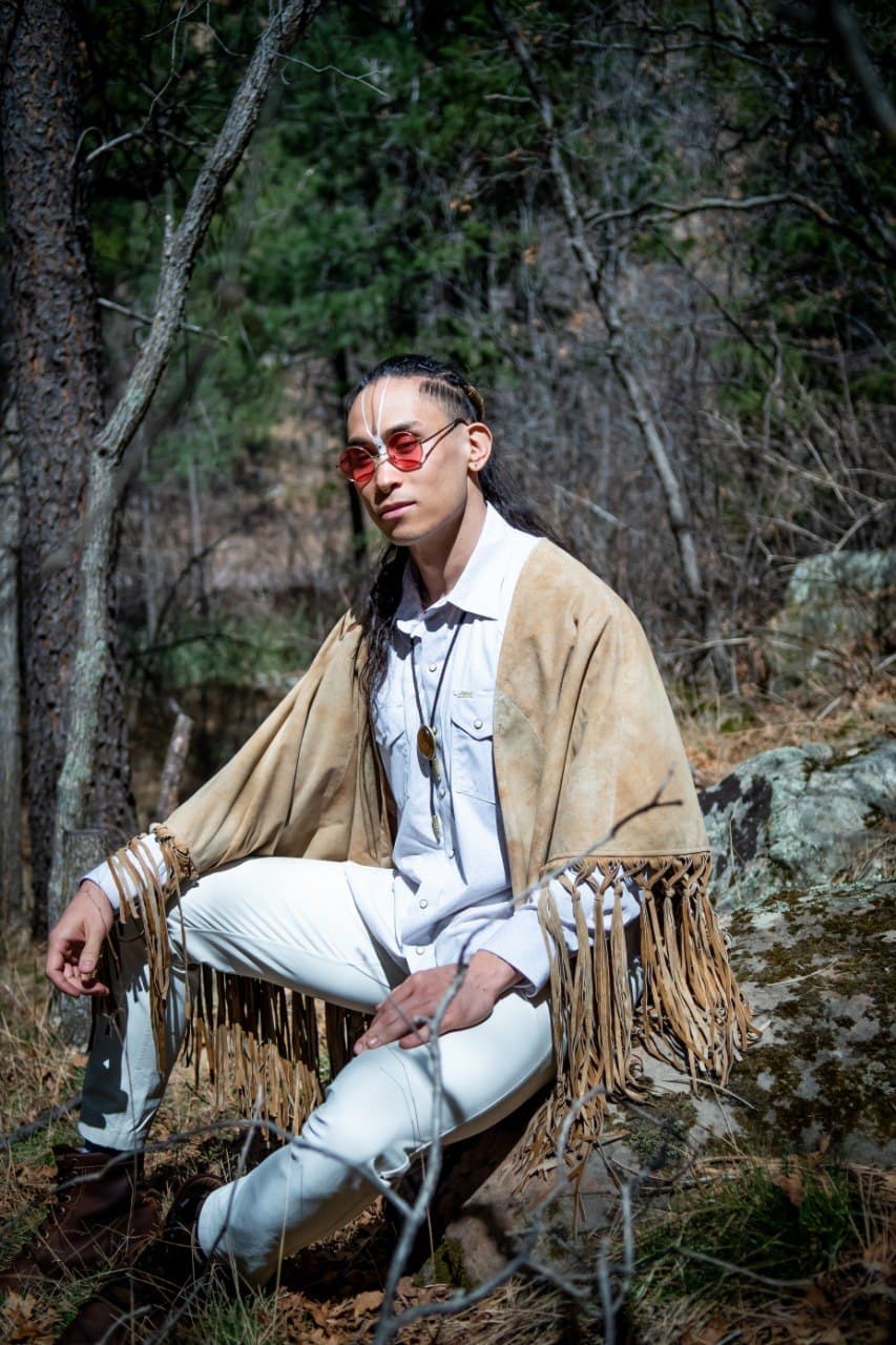 CBliss seated in ceremonial attire during outdoor training